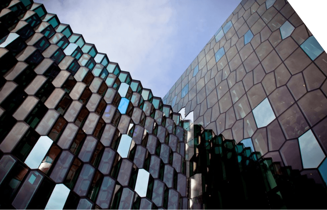 a large building with a lot of windows is lit up at sunset .