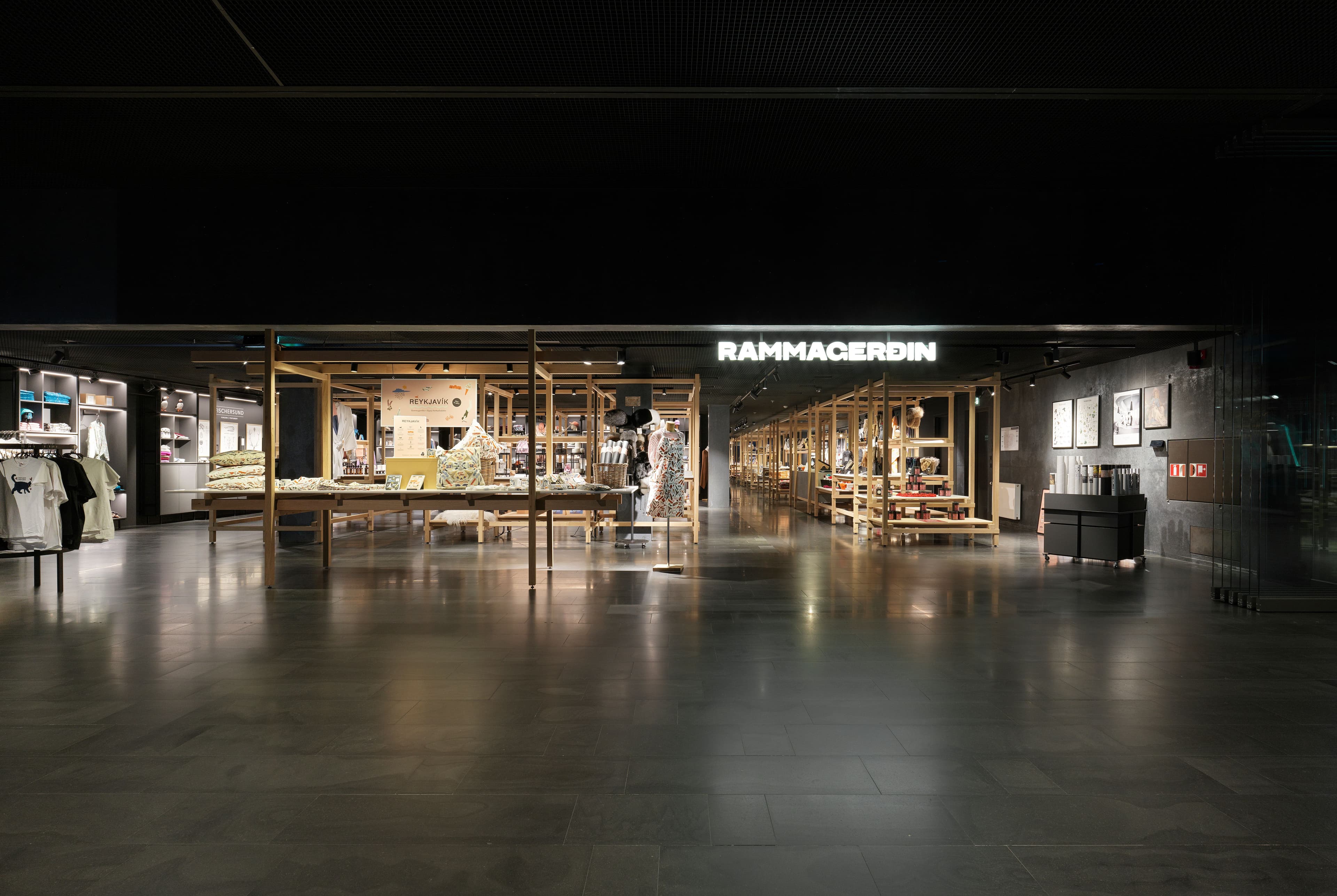 RAMMACERDIN store interior with merchandise on wooden display frames.